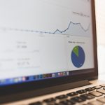 A laptop screen displays data analytics showcasing SEO techniques and best practices.