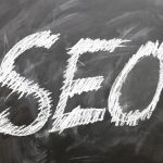 Chalkboard with 'SEO' written in white, representing SEO services