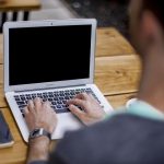 A person creating a blog on 10 effective tips for creating content that stands out.